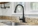 Close-up of a modern kitchen sink with a black faucet and granite countertop at 1212 Pinopolis Rd, Moncks Corner, SC 29461