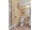 Cozy bathroom showcasing a glass door shower, pedestal sink, and neutral-toned tiled floors at 1213 Waterfront Dr, Mount Pleasant, SC 29464