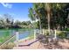 Outdoor deck area with a table set overlooking calm water and lush greenery on a sunny day at 1213 Waterfront Dr, Mount Pleasant, SC 29464