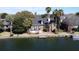 Waterfront house with palm trees and a private dock offering picturesque views on a sunny day at 1213 Waterfront Dr, Mount Pleasant, SC 29464