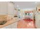 Bright kitchen featuring white cabinets, modern appliances, and a cozy breakfast nook at 1213 Waterfront Dr, Mount Pleasant, SC 29464