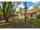 Large backyard with a trampoline, swing set, and grassy area, perfect for outdoor activities at 1257 Maryland Dr, Ladson, SC 29456
