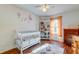 Brightly decorated Bedroom featuring hardwood floors, white crib, shelving, and natural light at 1257 Maryland Dr, Ladson, SC 29456