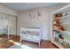 Brightly decorated Bedroom featuring hardwood floors, white crib, shelving, and closet at 1257 Maryland Dr, Ladson, SC 29456