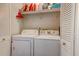 Laundry room with washer, dryer, and storage shelf, concealed by folding louvered doors at 1257 Maryland Dr, Ladson, SC 29456