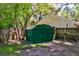 Backyard shot of a green storage shed with a shingled roof and privacy fence in the background at 1257 Maryland Dr, Ladson, SC 29456