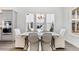 Elegant dining room features a large table, wicker chairs, and natural light from multiple windows at 136 Maritime Way, Summerville, SC 29485