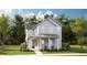 Charming two-story home with a welcoming front porch, lush lawn and classic blue siding, creating a picturesque curb appeal at 136 Maritime Way, Summerville, SC 29485