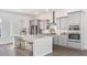 Modern kitchen with stainless steel appliances, island with breakfast bar, and gray cabinetry at 136 Maritime Way, Summerville, SC 29485