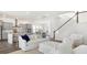 Bright and airy living room showcases open layout to the kitchen and staircase at 136 Maritime Way, Summerville, SC 29485