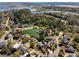 Aerial view of the community, showcasing homes around a pond and adjacent to a river at 1369 Tidal Creek Cv, Charleston, SC 29412