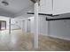 Finished basement with herringbone tile flooring, white support beams, and partial kitchen area at 1369 Tidal Creek Cv, Charleston, SC 29412