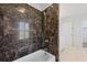 Bathroom showcasing a tiled shower with marble-look tile and an adjustable shower head at 1369 Tidal Creek Cv, Charleston, SC 29412