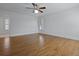 Bedroom showcasing hardwood floors, white trim, ceiling fan, and shuttered windows at 1369 Tidal Creek Cv, Charleston, SC 29412