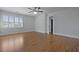 Light-filled bedroom with wood floors, ceiling fan, and shuttered windows with an ensuite bathroom at 1369 Tidal Creek Cv, Charleston, SC 29412