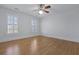 Bright bedroom featuring hardwood floors, white walls, plantation shutters, and a ceiling fan at 1369 Tidal Creek Cv, Charleston, SC 29412