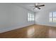 Bright bedroom featuring hardwood floors, white walls, plantation shutters, and a ceiling fan at 1369 Tidal Creek Cv, Charleston, SC 29412