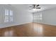 Spacious bedroom featuring beautiful hardwood floors, white trim, and natural light from shuttered windows at 1369 Tidal Creek Cv, Charleston, SC 29412