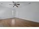 Bedroom with hardwood floors, white walls, plantation shutters, and ceiling fan at 1369 Tidal Creek Cv, Charleston, SC 29412