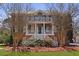 Stately two-story home featuring a welcoming front porch with columns and lush landscaping at 1369 Tidal Creek Cv, Charleston, SC 29412