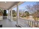 Spacious front porch with classic white columns, providing a relaxing outdoor living space with neighborhood views at 1369 Tidal Creek Cv, Charleston, SC 29412