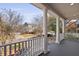 Inviting covered front porch with white railings and columns, offering scenic neighborhood views at 1369 Tidal Creek Cv, Charleston, SC 29412