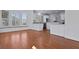 Open-concept kitchen features white cabinetry, granite countertops, and hardwood floors at 1369 Tidal Creek Cv, Charleston, SC 29412