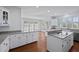 Bright kitchen with white cabinets, granite counters, stainless appliances, and hardwood floors at 1369 Tidal Creek Cv, Charleston, SC 29412