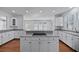 Open kitchen design with white cabinets, granite counters, an island, and modern appliances at 1369 Tidal Creek Cv, Charleston, SC 29412