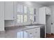 Kitchen sink and countertop area with white cabinets, granite countertops, and natural light at 1369 Tidal Creek Cv, Charleston, SC 29412