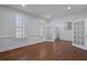 Bright living room with wood floors, white walls, and shuttered windows at 1369 Tidal Creek Cv, Charleston, SC 29412