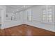 Bright room featuring wood floors, white walls, and plantation shutters at 1369 Tidal Creek Cv, Charleston, SC 29412