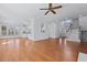 Open-concept living space with hardwood floors, high ceilings, and seamless flow to kitchen and stairs at 1369 Tidal Creek Cv, Charleston, SC 29412