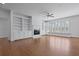 Bright living room with hardwood floors, built-in shelving, a fireplace, and abundant natural light at 1369 Tidal Creek Cv, Charleston, SC 29412