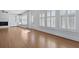Bright living room with a fireplace, built-in shelving, and large windows with plantation shutters at 1369 Tidal Creek Cv, Charleston, SC 29412