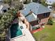 Aerial view of the backyard with a luxurious pool, hot tub, and beautiful deck in a brick home setting at 1369 Tidal Creek Cv, Charleston, SC 29412