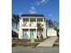 Charming two-story home boasts a covered porch, blue door and a well-manicured front yard, enhancing curb appeal at 149 Greenbelt Ct, Summerville, SC 29485