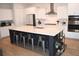 Spacious kitchen with a large center island, white cabinets, stainless steel appliances, and barstool seating at 149 Greenbelt Ct, Summerville, SC 29485