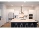 Well-appointed kitchen with white cabinets, a large island with seating, and modern stainless-steel appliances at 149 Greenbelt Ct, Summerville, SC 29485