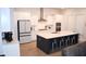 Modern kitchen features white cabinets, stainless steel appliances, and a large center island with seating at 149 Greenbelt Ct, Summerville, SC 29485