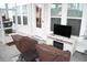 Relaxing covered porch with television, chairs, and table with neutral color palette at 149 Greenbelt Ct, Summerville, SC 29485