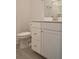 Bright bathroom showcases a white vanity with modern hardware and a tiled floor near the toilet at 1510 Cecile St, Mount Pleasant, SC 29464