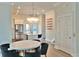 Open kitchen and dining area featuring stainless appliances, island with seating, and decorative lighting at 1510 Cecile St, Mount Pleasant, SC 29464
