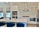 A gourmet kitchen with white cabinetry, stainless steel appliances, and a large island, perfect for cooking and entertaining at 1510 Cecile St, Mount Pleasant, SC 29464