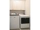 Modern laundry room featuring white Maytag washer and dryer units at 1510 Cecile St, Mount Pleasant, SC 29464