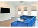 A stylish living room boasts hardwood floors, a modern sofa, and plenty of natural light from large windows at 1510 Cecile St, Mount Pleasant, SC 29464