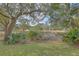 Lush backyard featuring mature trees and natural vegetation creating a private retreat at 1626 Bull Creek Ln, Charleston, SC 29414