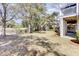 Large backyard with well manicured lawn, mature trees and a view of surrounding homes at 1626 Bull Creek Ln, Charleston, SC 29414