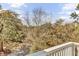 View of the wooded backyard area from the balcony with white railings at 1626 Bull Creek Ln, Charleston, SC 29414