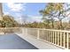 Outdoor balcony overlooks a wooded area and features white railing and a gray floor at 1626 Bull Creek Ln, Charleston, SC 29414
